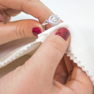 Polishing a diamond ring with a jewelry polishing cloth