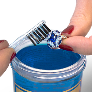 cleaning a ring with a jewelry cleaner brush