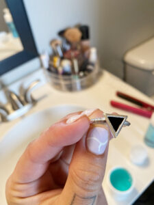 girl holding a ring that was cleaned by The Kingswood Company Jewelry Cleaner