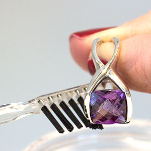 Cleaning jewelry with a brush