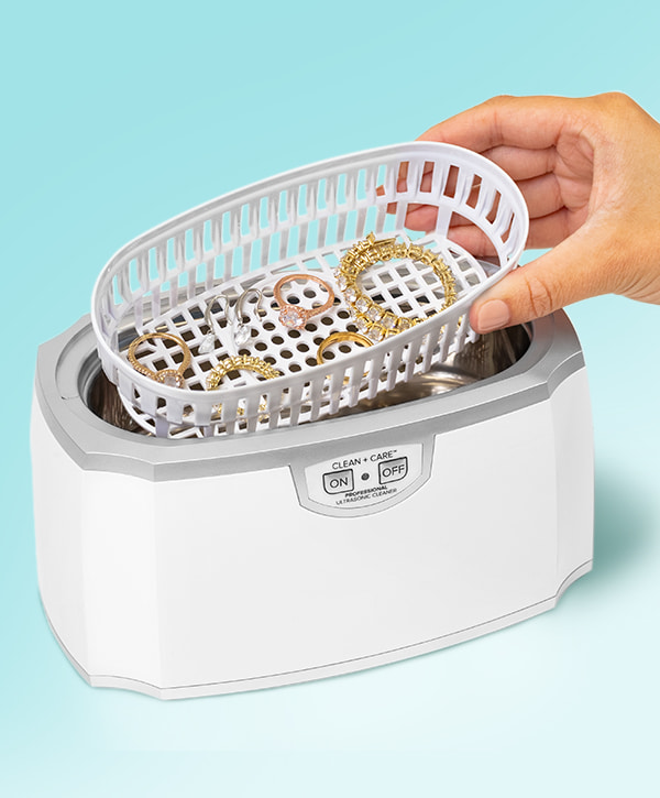 Clean + Care ultrasonic cleaner being used on different jewelry pieces